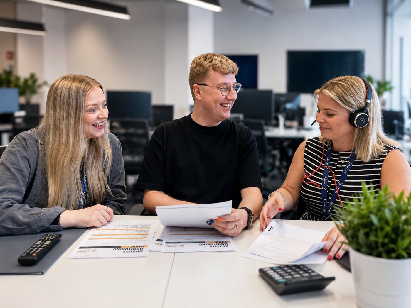 Unity Connect team members reviewing quality monitoring forms together